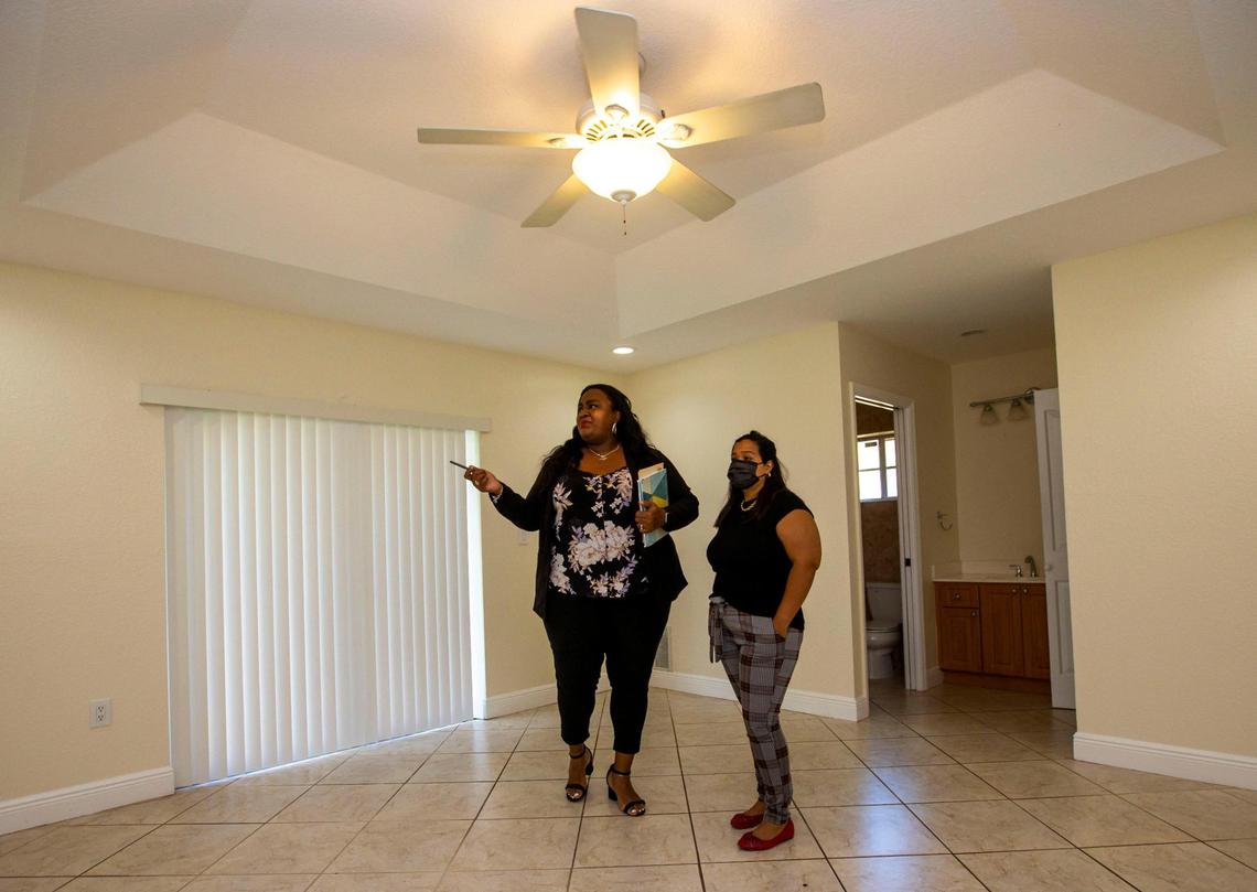Dawn N. Reid Broker/CEO of Gladiator Realty Group shows her client Melissa Usubillaga a property for sale in Miami on Friday, March 4, 2022.