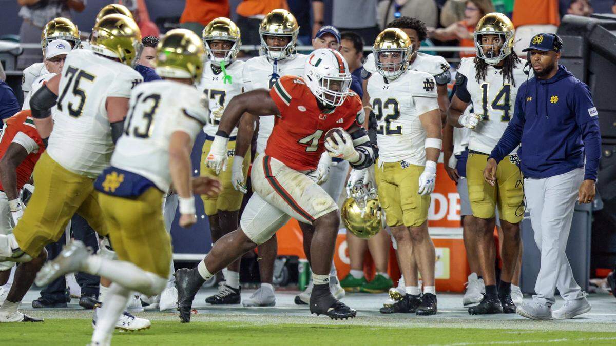 Miami Hurricanes defensive lineman Rueben Bain Jr. (4) runs after intercepting the ball in the fourth quarter during an NCAA football game Notre Dame Fighting Irish at Hard Rock Stadium in Miami Gardens, Florida, on Sunday, August 31, 2025. 