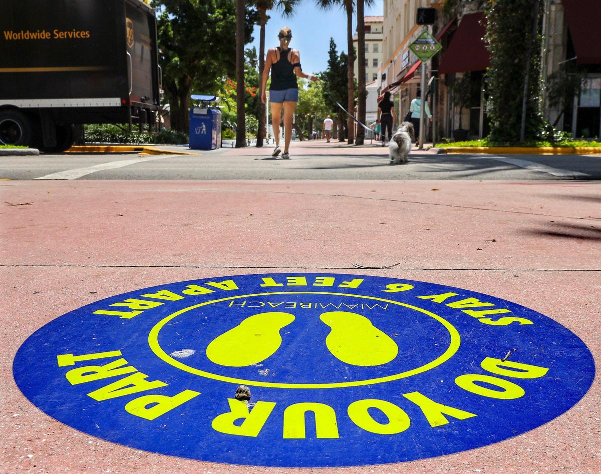 Signage encourage social distancing for healthy shopping while some of Lincoln Road Mall businesses reopened as part of Phase One.