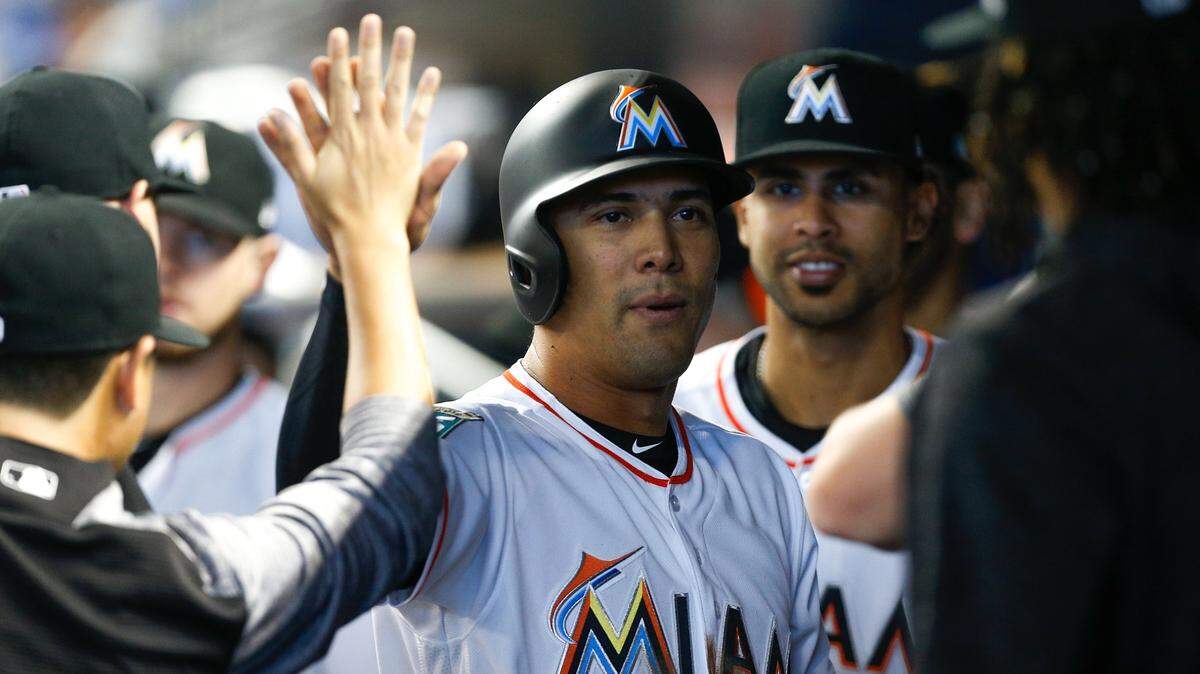 MIAMI, FL - AUGUST 12:  Rafael Ortega #52 of the Miami Marlins celebrates with teammates after scoring in the first inning against the New York Mets at Marlins Park on August 12, 2018 in Miami, Florida.  (Photo by Michael Reaves/Getty Images)