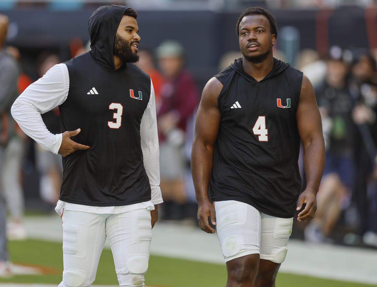 Miami Hurricanes defensive lineman Akheem Mesidor (3) and Miami Hurricanes defensive lineman Rueben Bain Jr. (4) walk on the field together before the NCAA football game against the Syracuse Orange at Hard Rock Stadium in Miami Gardens, Florida on Saturday, November 8, 2025.