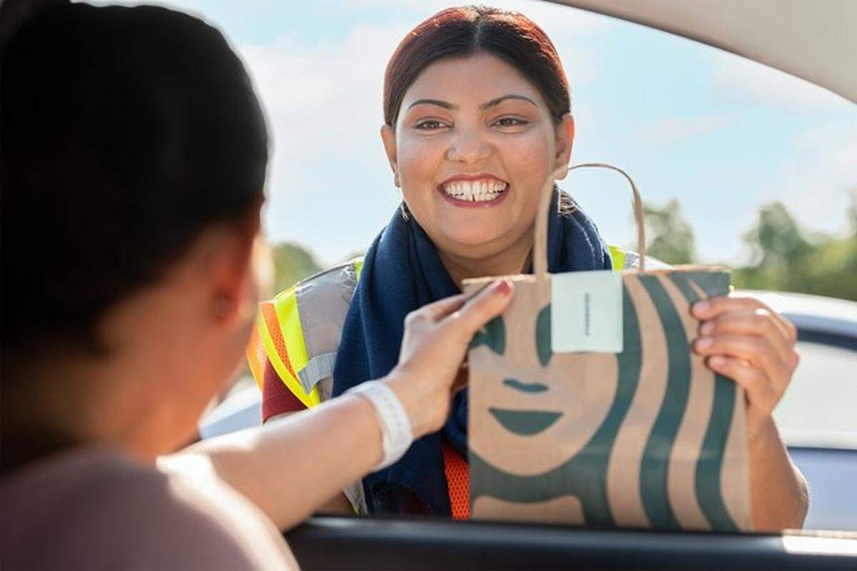 Target rolled out its Starbucks Drive Up curbside delivery program nationally in August 2023. The service is available at most of the Miami area’s 35 Targets. Here, a barista delivers an order to a customer’s car.
