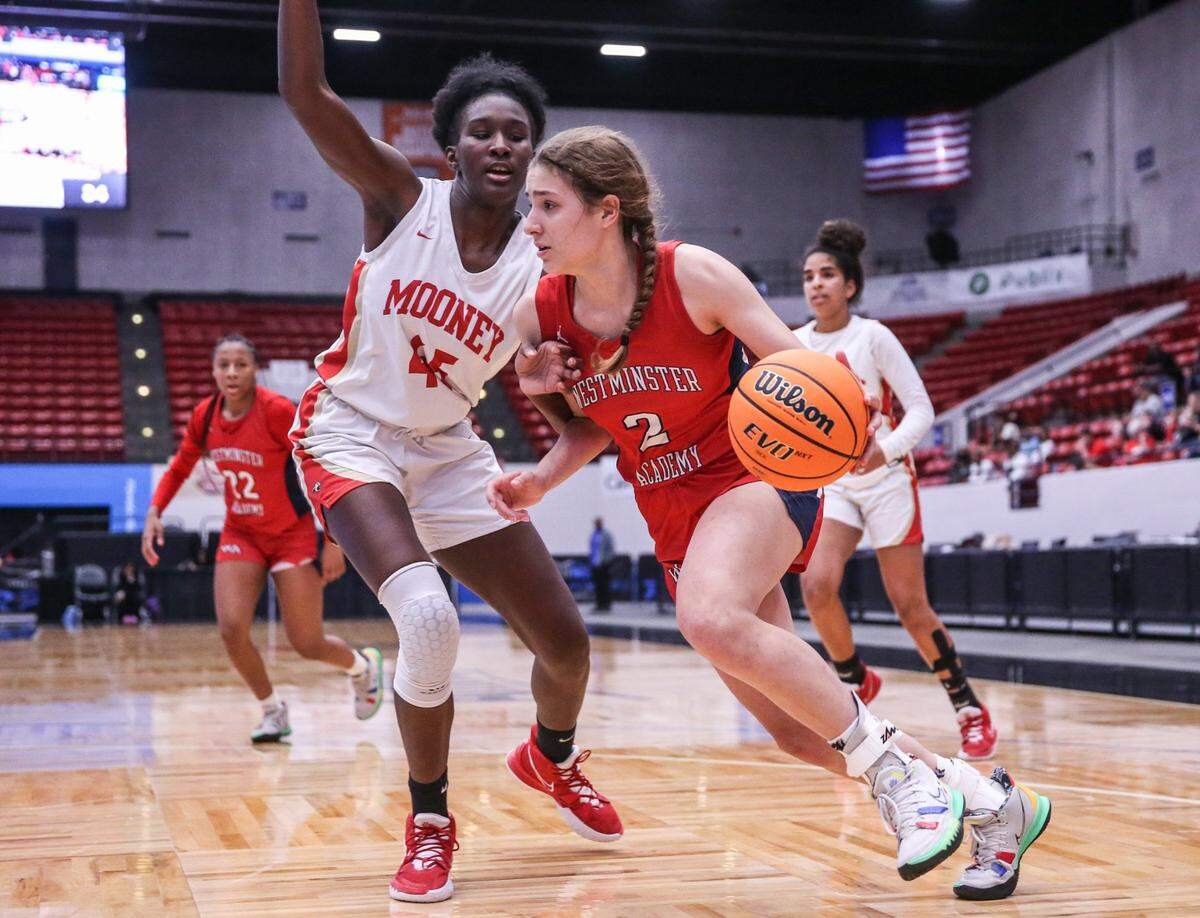 Westminster Academys Lena Giardi (2) drives the ball as Cardinal Mooneys Jordyn Byrd (45) defends in a Class 3A girls basketball state championship at the RP Funding Center in Lakeland on Friday, February 25, 2022.