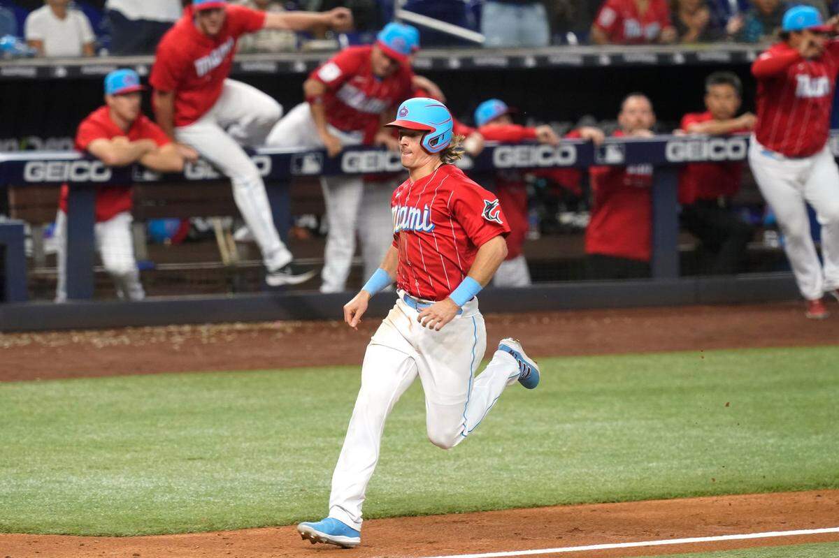 Miami Marlins Luke Williams runs to score the winning run in the ninth inning of a baseball game after the game, Saturday, June 4, 2022, in Miami. The Marlins defeated the Giants 5-4. (AP Photo/Marta Lavandier)
