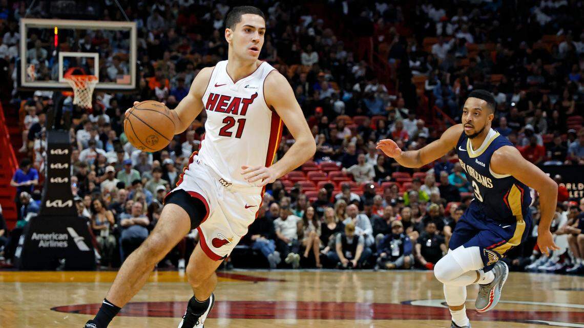 Miami Heat forward Cole Swider (21) drives the ball as New Orleans Pelicans guard CJ McCollum (3) gives chase in the fourth quarter at Kaseya Center in Miami on Friday, March 22, 2024.