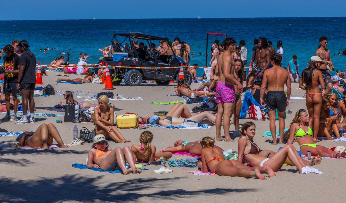 Police officers seen as spring breakers enjoy the nice weather at Fort Lauderdale Beach.