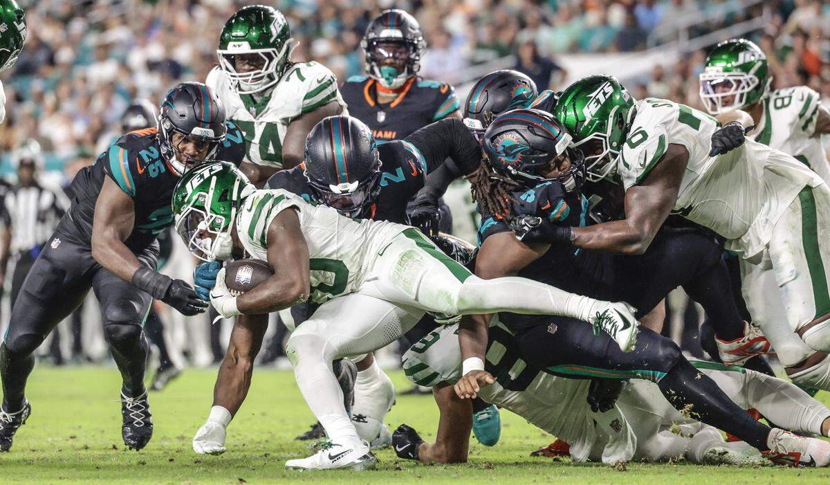 New York Jets running back Breece Hall (20) battles the Miami Dolphins defense for yardage in the second half during their NFL game at Hard Rock Stadium in Miami Gardens, Florida, on Monday, September 29, 2025. 