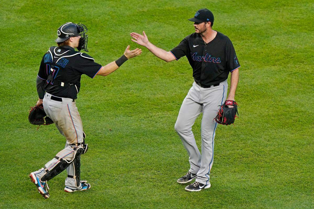 Miami Marlins catcher Chad Wallach (17) congratulates relief pitcher James Hoyt who replaced Daniel Castano in the ninth inning of their shutout of the New York Yankees, Sunday, Sept. 27, 2020, at Yankee Stadium in New York. (AP Photo/Kathy Willens)