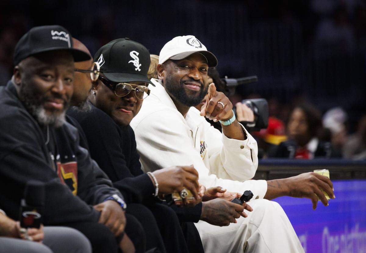 Dwayne Wade, Basketball Hall of Fame inductee and former Miami Heat player, points to the camera during the first half of a Miami Heat game against the Atlanta Hawks on Tuesday, Feb. 3, 2026, at the Kaseya Center in downtown Miami, Fla.  