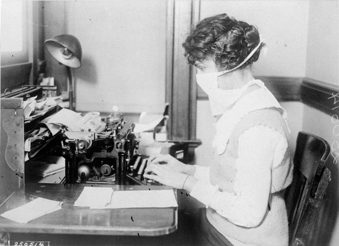 A New York City typist wears a mask in October 1918.