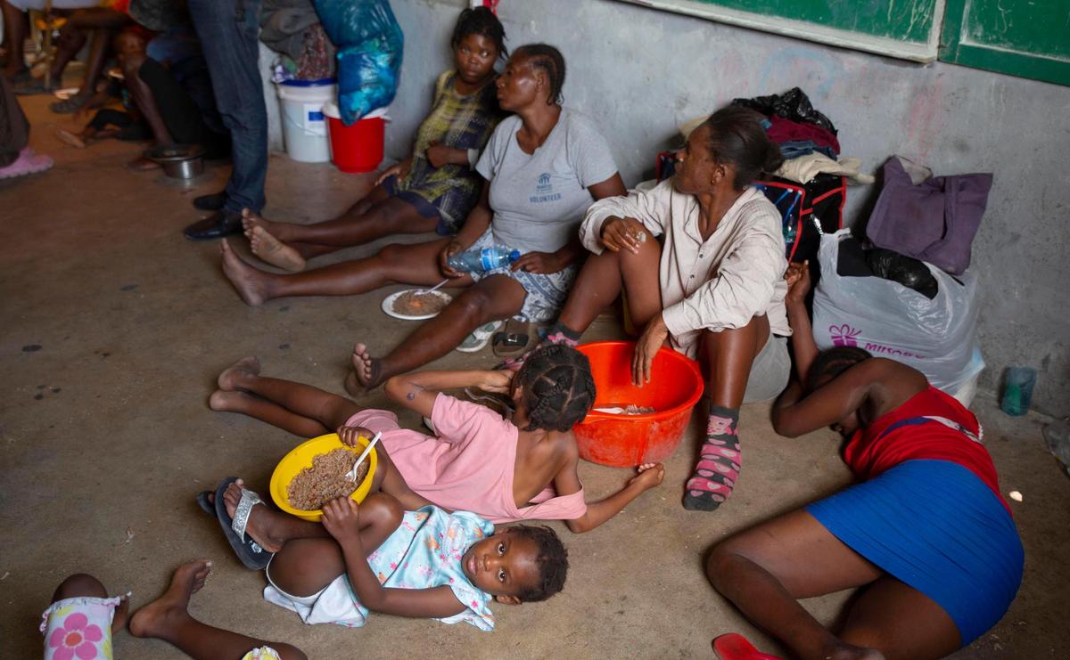 A group of blind and disabled people stay at a refuge for displaced persons on Thursday, June 24, 2021, a week after armed gangs set their homes on fire in Port-au-Prince, Haiti.