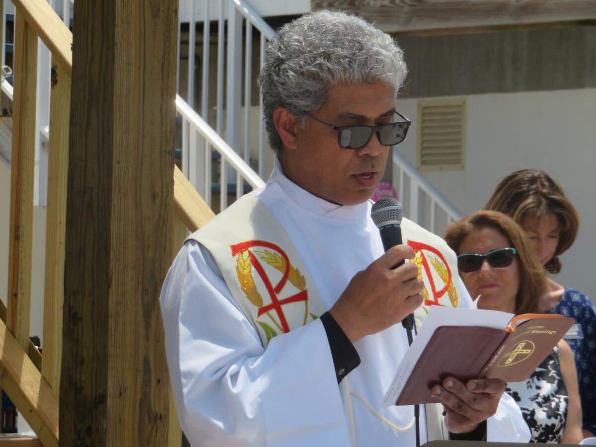 Father Jets Medina blesses the Keys Cottage on Aug. 16, 2018, in Big Pine Key.