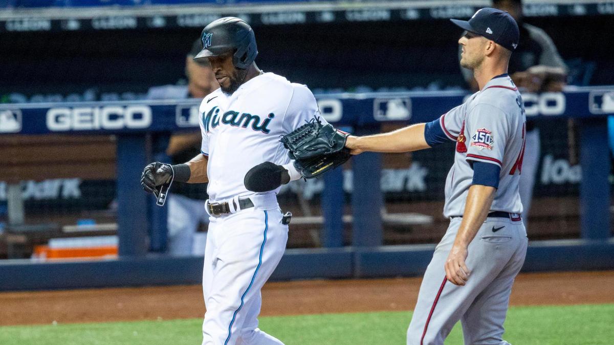 Miami Marlins base runner Starling MarteÂ (6) crosses home plate during the seventh inning of an MLB game against the Atlanta Braves at loanDepot park in the Little Havana neighborhood of Miami, Florida, on Sunday, June 13, 2021.