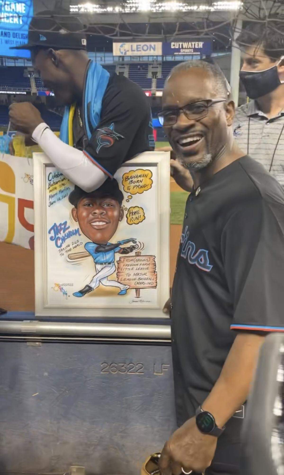 Bahamas Minister of Youth, Sports and Culture Iram Lewis presented a caricature painting to shortstop Jasrado “Jazz” Prince Hermis Arrington Chisholm Jr., a star rookie for the Marlins.