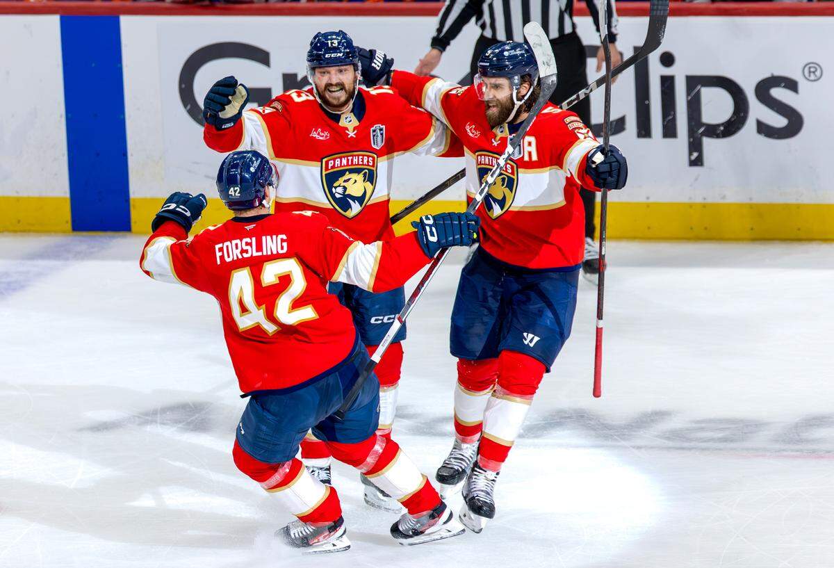 Florida Panthers center Sam Reinhart (13) celebrates with teammates Aaron Ekblad (5) and Gustav Forsling (42) after scoring his third goal of the game against the Edmonton Oilers during the third period of Game 6 in the NHL Stanley Cup Final at Amerant Bank Arena on Tuesday, June 17, 2025, in Sunrise, Fla.