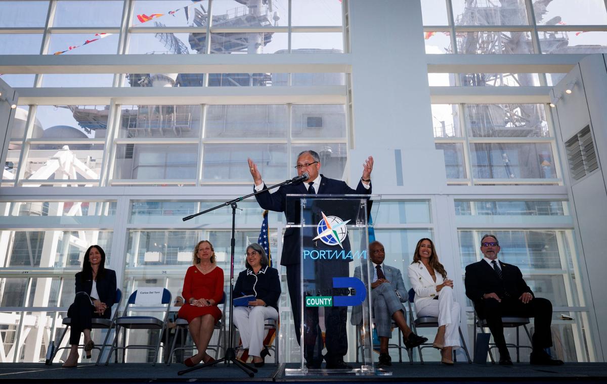 Carlos Del Toro, United States Secretary of the Navy, speaks during the opening day of Fleet Week with the assault ship USS Bataan (LHD-5) behind him on Monday, May 6, 2024, at Norwegian Cruise Lines Terminal in PortMiami.