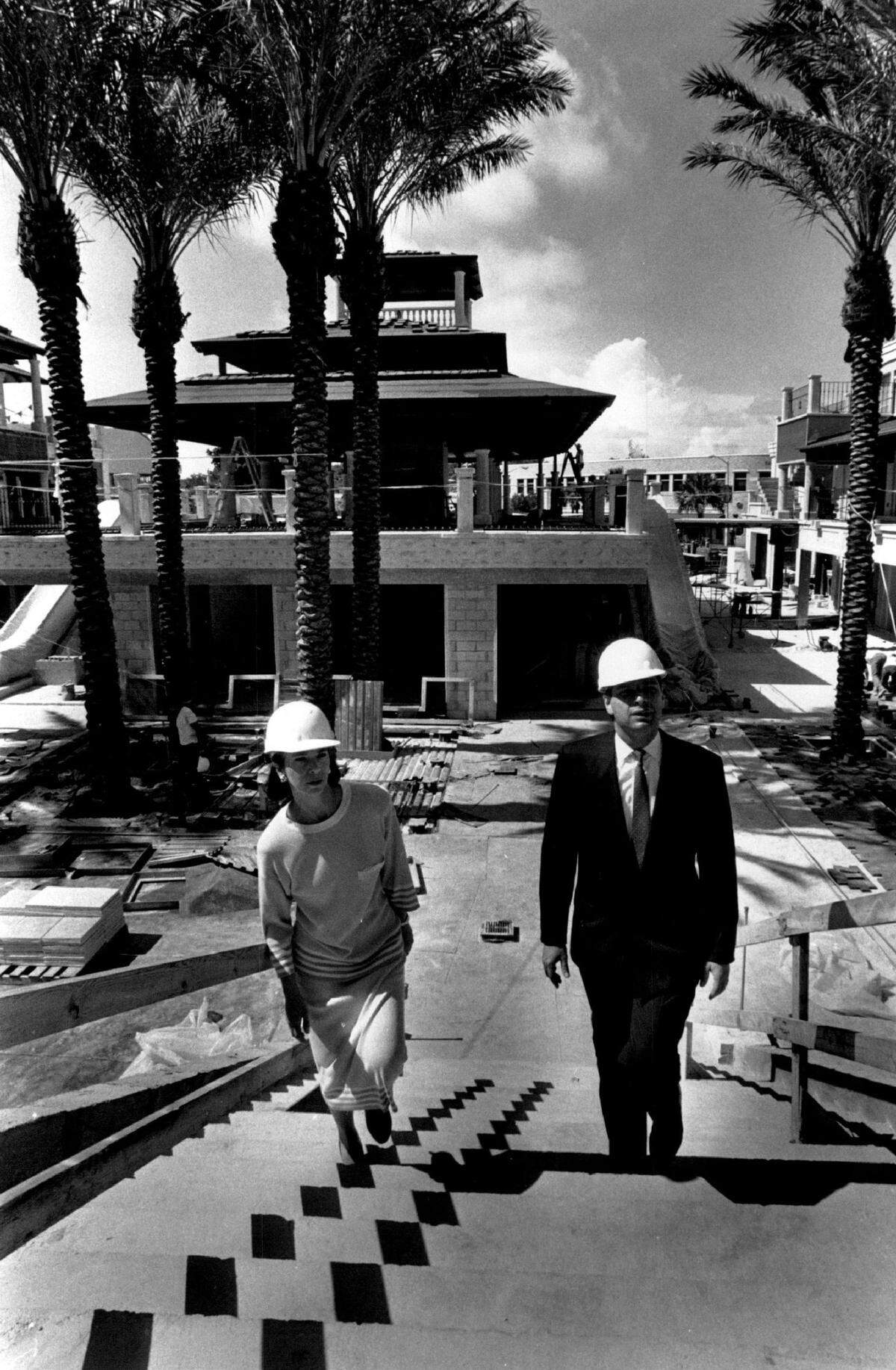Executives walk through through CocoWalk under construction in 1990.