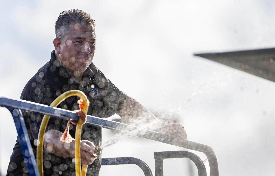 Andres Martinez cleans the Schwartz Center for Athletic Excellence at the University of Miami on Tuesday, Aug. 8, 2023, in Coral Gables, Fla. The National Weather Service has issued an excessive heat advisory Tuesday in parts of Florida.