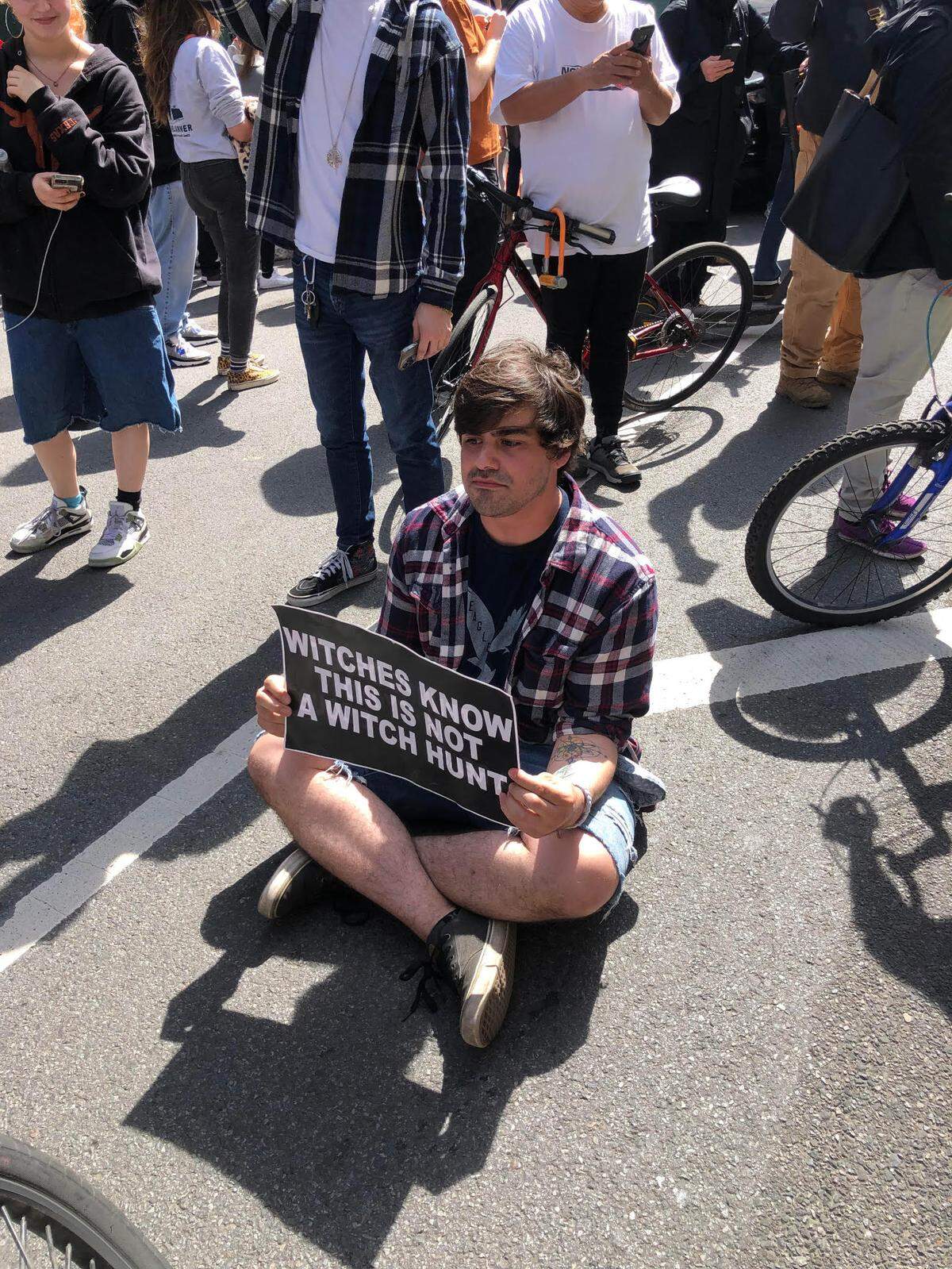 Protesters react to the people on the pedicab.