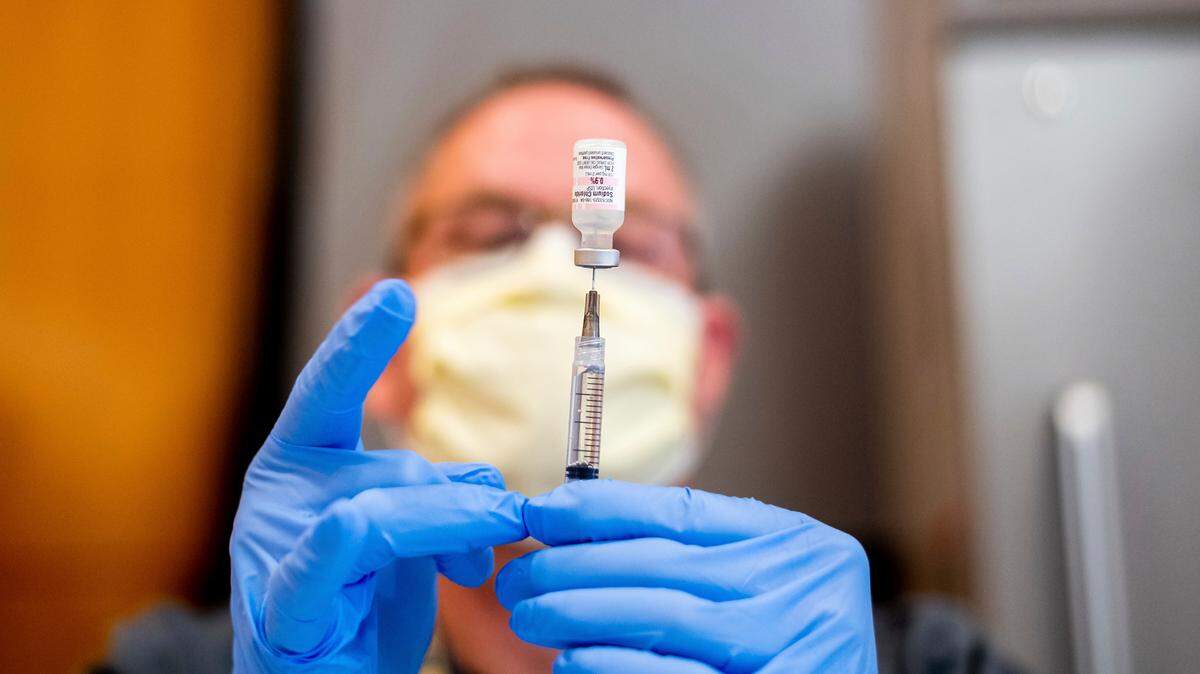 In this stock photo, pharmacist Brian Kiefer draws saline while preparing a dose of Pfizer’s COVID-19 vaccine at UC Davis Health on Tuesday, Jan. 12, 2021, in Sacramento, California.