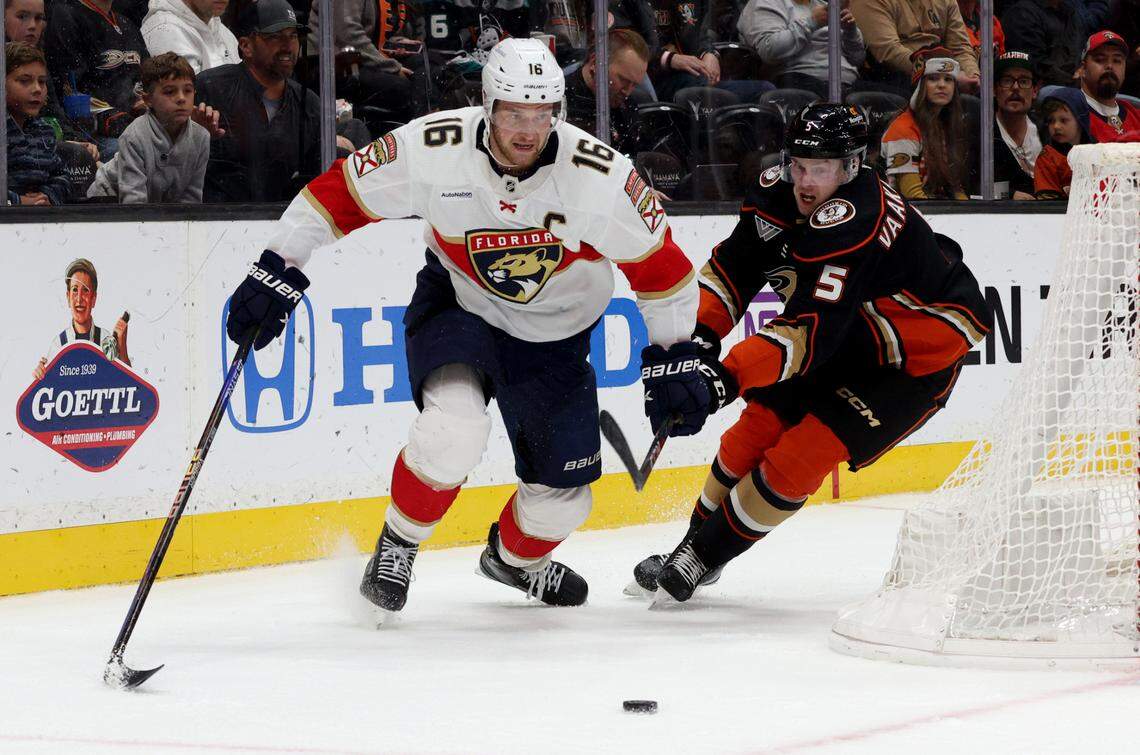 Nov 17, 2023; Anaheim, California, USA; Florida Panthers center Aleksander Barkov (16) and Anaheim Ducks defenseman Urho Vaakanainen (5) chase a loose puck during the first period at Honda Center. Mandatory Credit: Jason Parkhurst-USA TODAY Sports