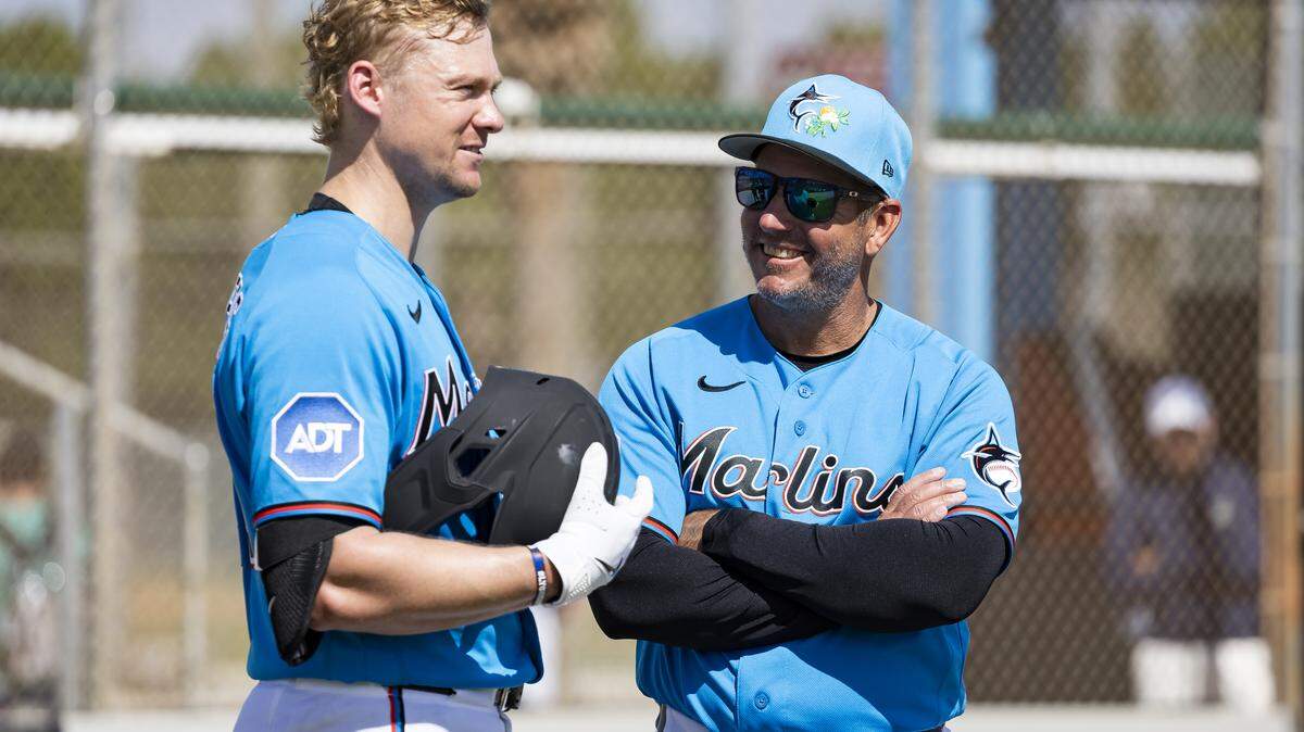 Miami Marlins left fielder Kyle Stowers (28) and manager Clayton McCullough (86) talk during the team’s first full-squad spring training workout at Roger Dean Stadium on Monday, Feb. 16, 2026, in Jupiter, Fla.
