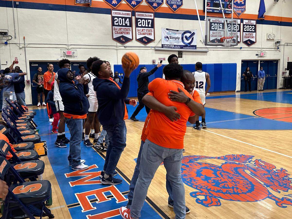 Stranahan boys’ basketball coaches share a hug as the final buzzer sounds on their 72-61 victory over Miami St. Brendan in the Region 4-4A championship game at the Dragons’ home gym in Fort Lauderdale.