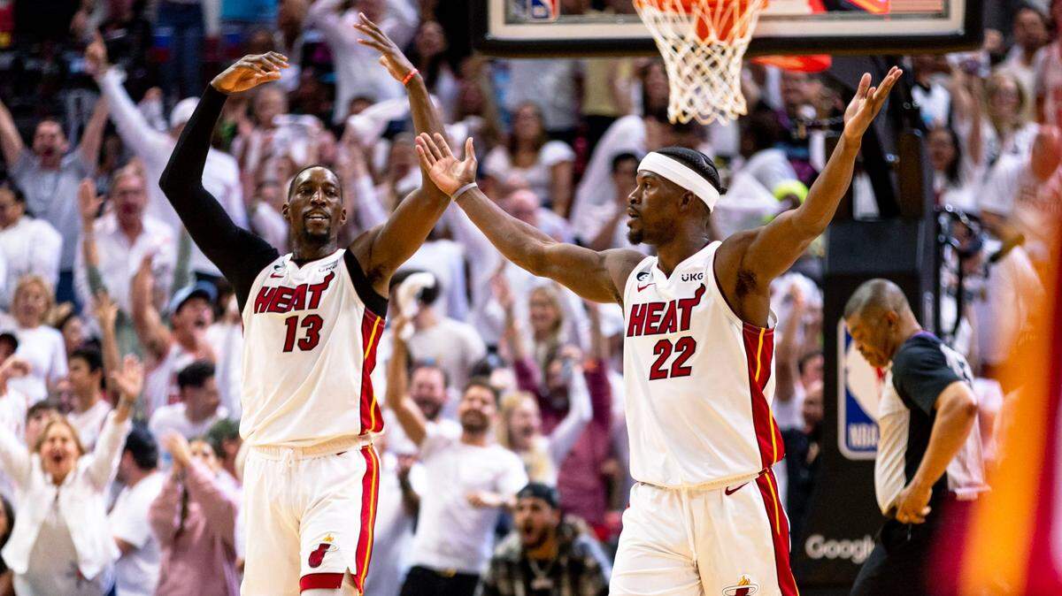 Miami Heat forward Jimmy Butler (22) and center Bam Adebayo (13) react during the second half of Game 3 of the NBA Eastern Conference Finals series against the Boston Celtics at Kaseya Center in Miami, Florida, on May 21, 2023.