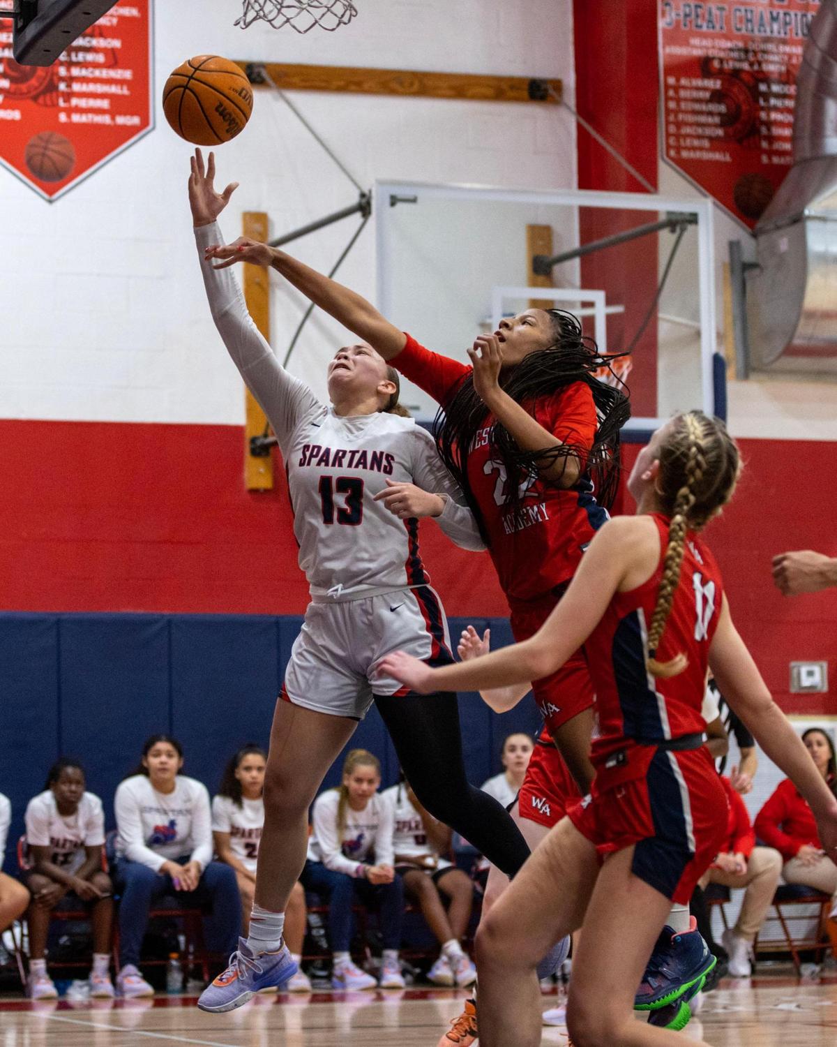 Miami Country Day’s Jalynn Belton (13) drives on Westminster Academy’s Taelynn Carey (22) during the Region 4-3A girls basketball final in Miami, Florida, on Friday, February 17, 2023.