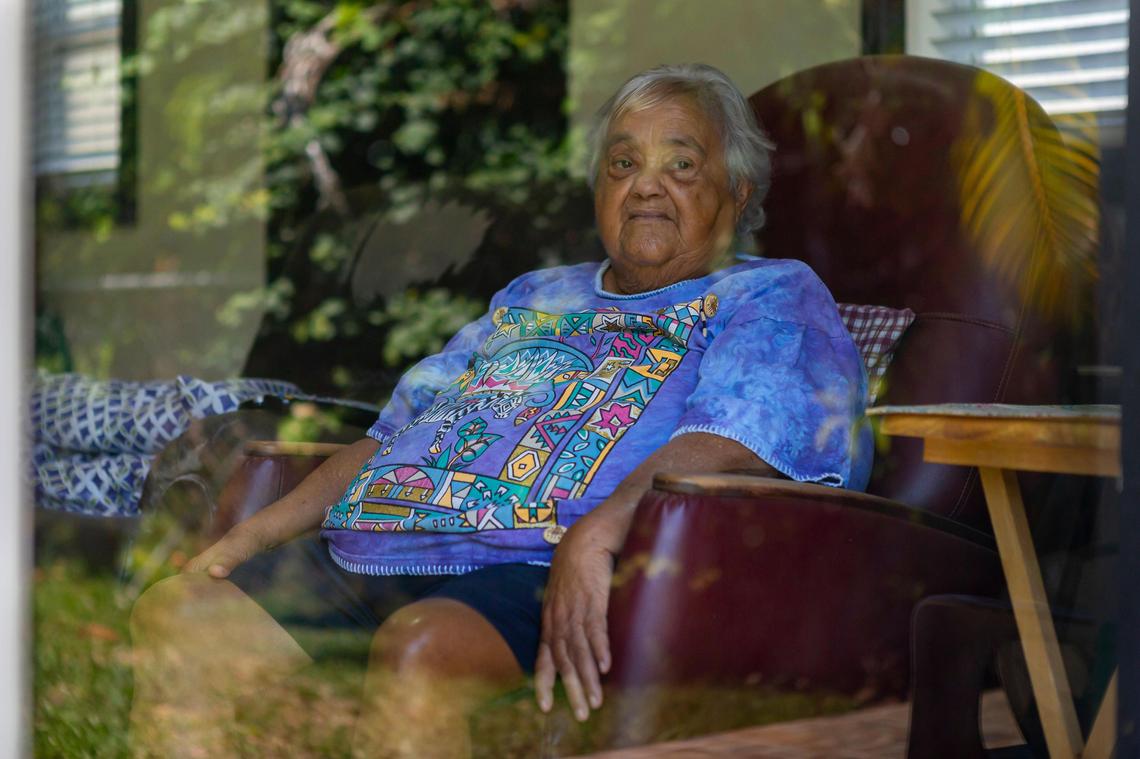 Milagro Morales, 81, who suffers from dementia, looks out from her living room window at her home in Miami’s Fontainebleau neighborhood on Saturday, May 9, 2020. Morales’ daughter, Mily Lopez, is her primary caregiver.