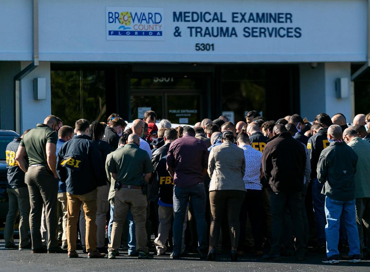 FBI agents stand outside of the Broward County Office of Medical Examiner and Trauma Services in Fort Lauderdale, Florida, on Tuesday, February 2, 2021. Two FBI agents were shot and killed and others injured while serving a warrant at a Sunrise home near Nob Hill Road and Northwest 44th Street.