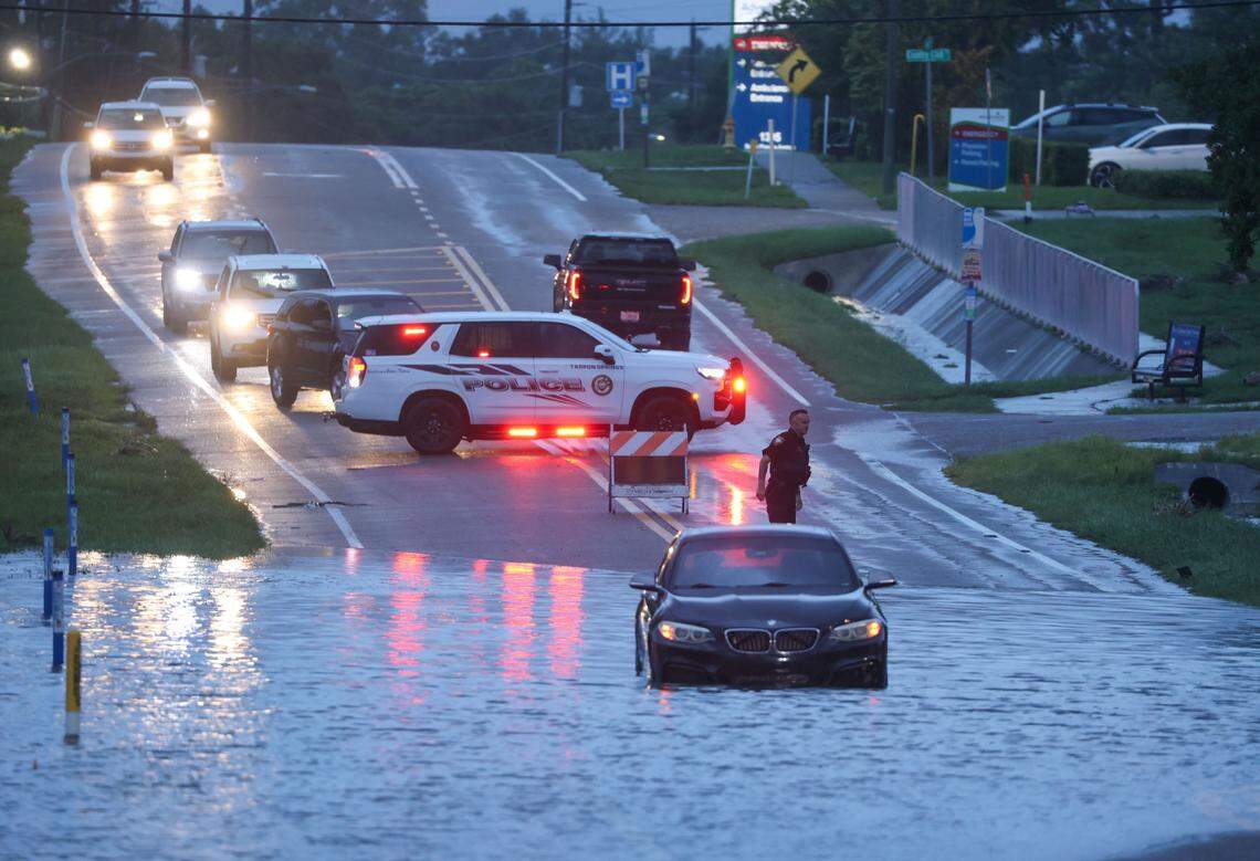 A BMW sedan is stalled in high water on southbound US Alt 19 in Tarpon Springs where flooding remained on roadways on Monday, Aug 5, 2024, as Tropical Storm Debby passes the Tampa Bay area offshore.