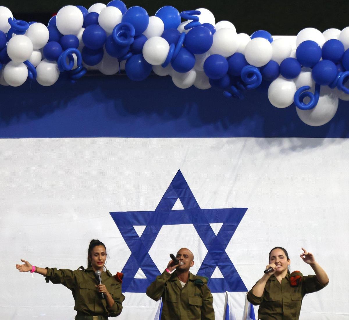 Israeli Defense Forces soldiers Moran Elbaz, left, Netanel Cohen, and Natalia Levi perform for attendees. On Wednesday, April 26, 2023, the South Florida community celebrated Israel’s 75th Independence Day. Over 6,000 convened at LoanDepot Park in Miami.
