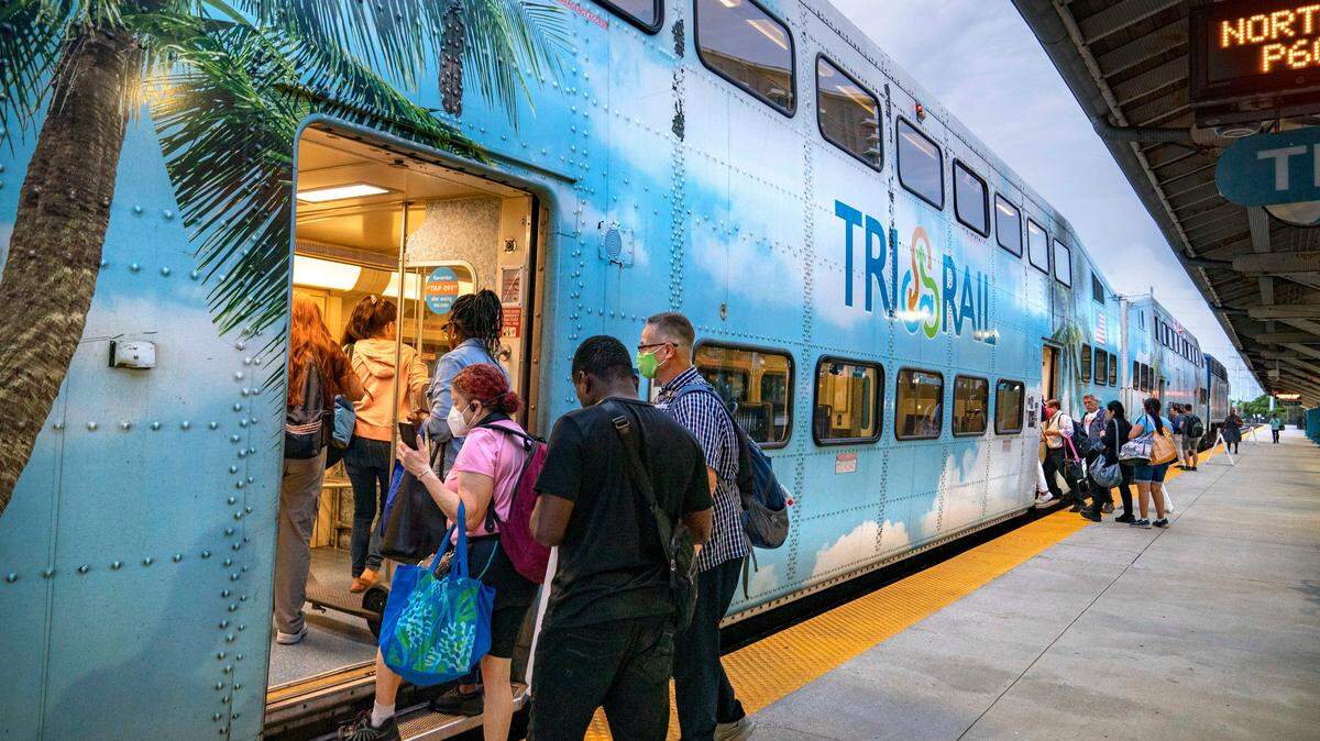 Passengers board a Tri-Rail train at the station on July 1, 2024, in West Palm Beach, Florida.
