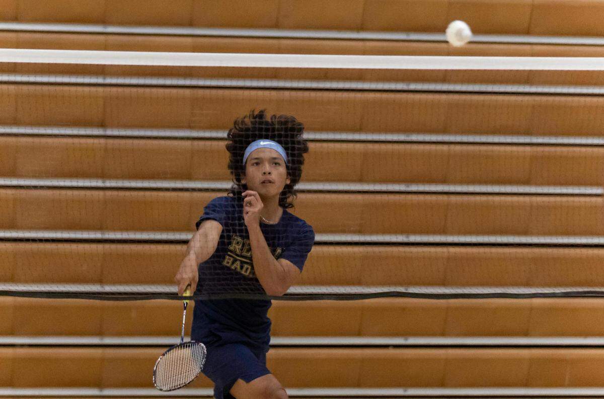 Ronald W. Reagan Senior High School’s Matthew Kang returns a shot to Felix Varela Senior High School’s Gabriel Pion as they play for the Boys’ singles badminton championship at G Holmes Braddock Senior High on Tuesday, April 18, 2023, in Miami, Fla.