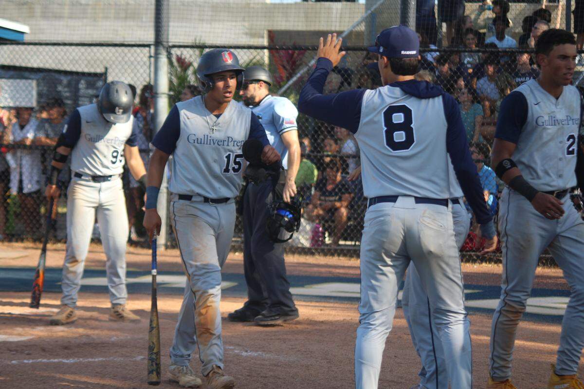 Gulliver’s A.J. Argudin (15) is greeted by happy teammates after scoring the Raiders first run of the game in the sixth inning of Tuesday’s Region 4-3A final win over Calvary Christian in Fort Lauderdale.
