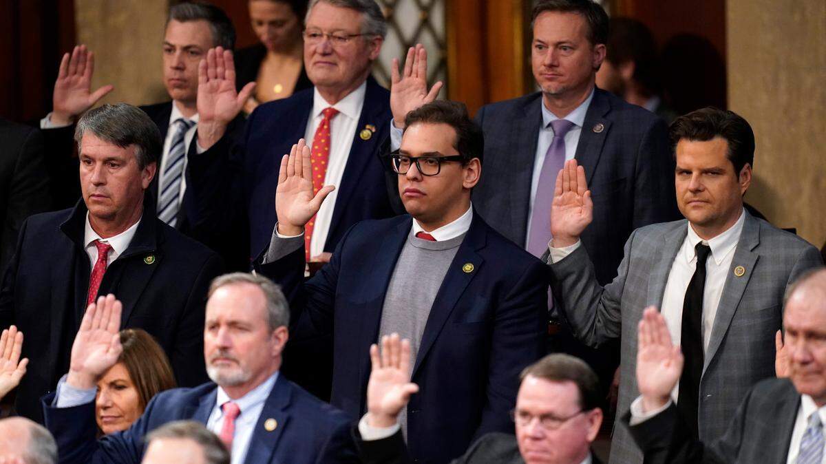 Rep. George Santos takes the oath of office. The fingers of his other hand were crossed.