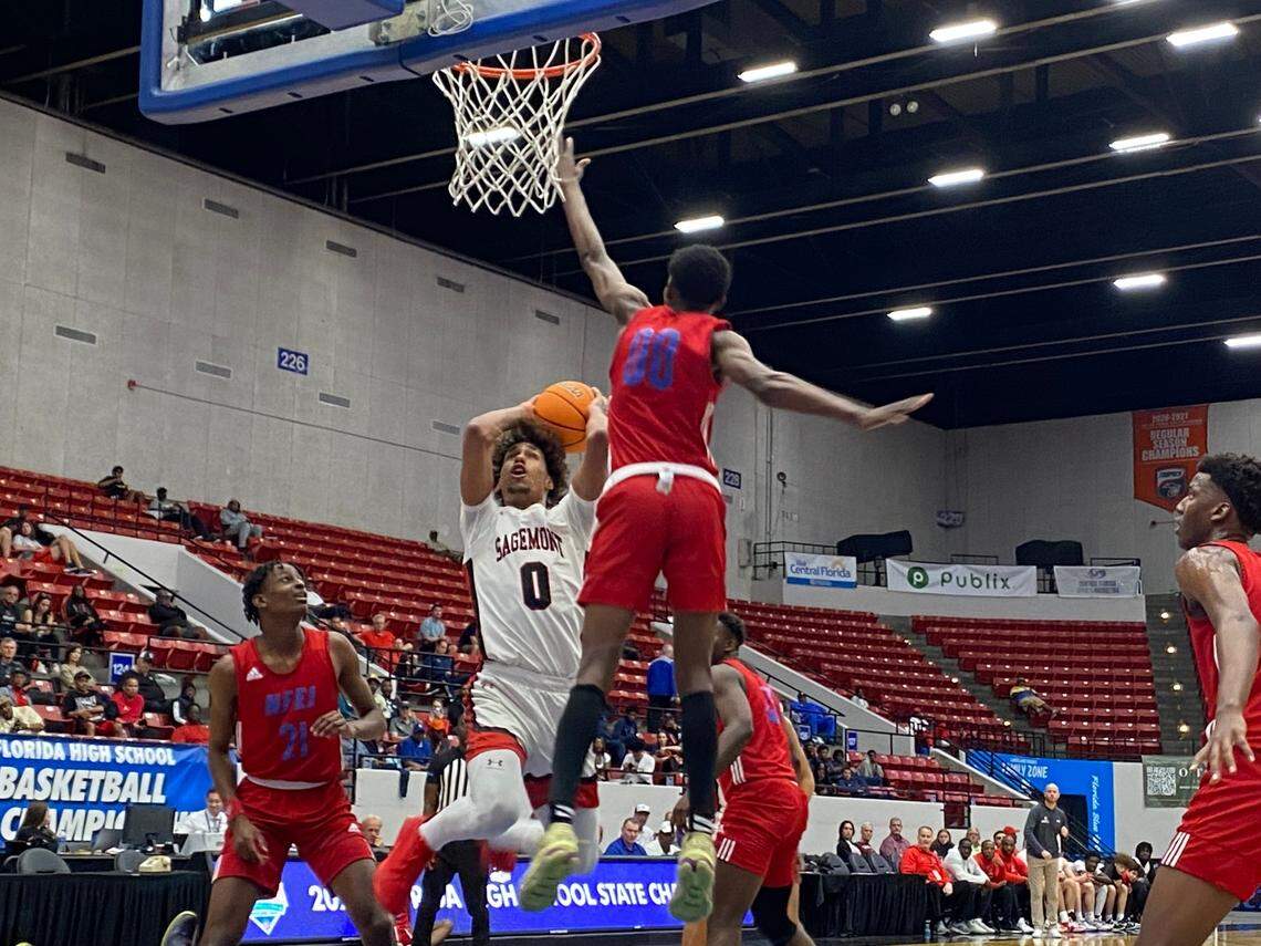 Sagemont guard Maxx Martinez challenges Jacksonville North Florida Educational Institute guard Juan Barbista (00) on a drive to the basket during Wednesday afternoon’s boys’ basketball Class 2A state semifinal at the RP Funding Center in Lakeland, Fla.