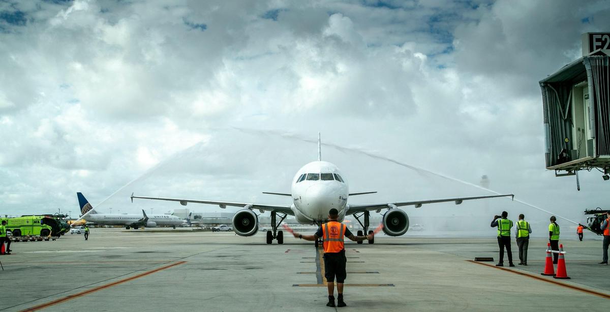 JetBlue flight #2992 from Newark, New Jersey, is guided into the gate at MIA under water canons on February 11, 2021.