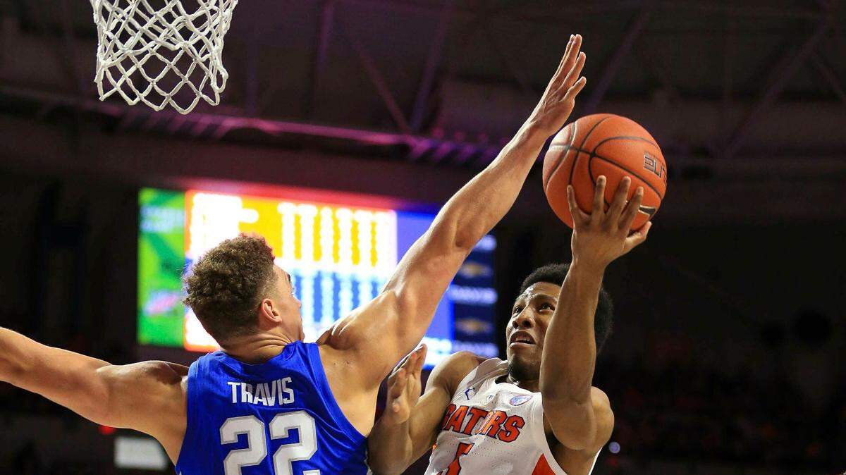 Florida guard KeVaughn Allen makes a layup past Kentucky forward Reid Travis during the first half of an NCAA college basketball game Saturday, Feb. 2, 2019, in Gainesville, Fla. (AP Photo/Matt Stamey)