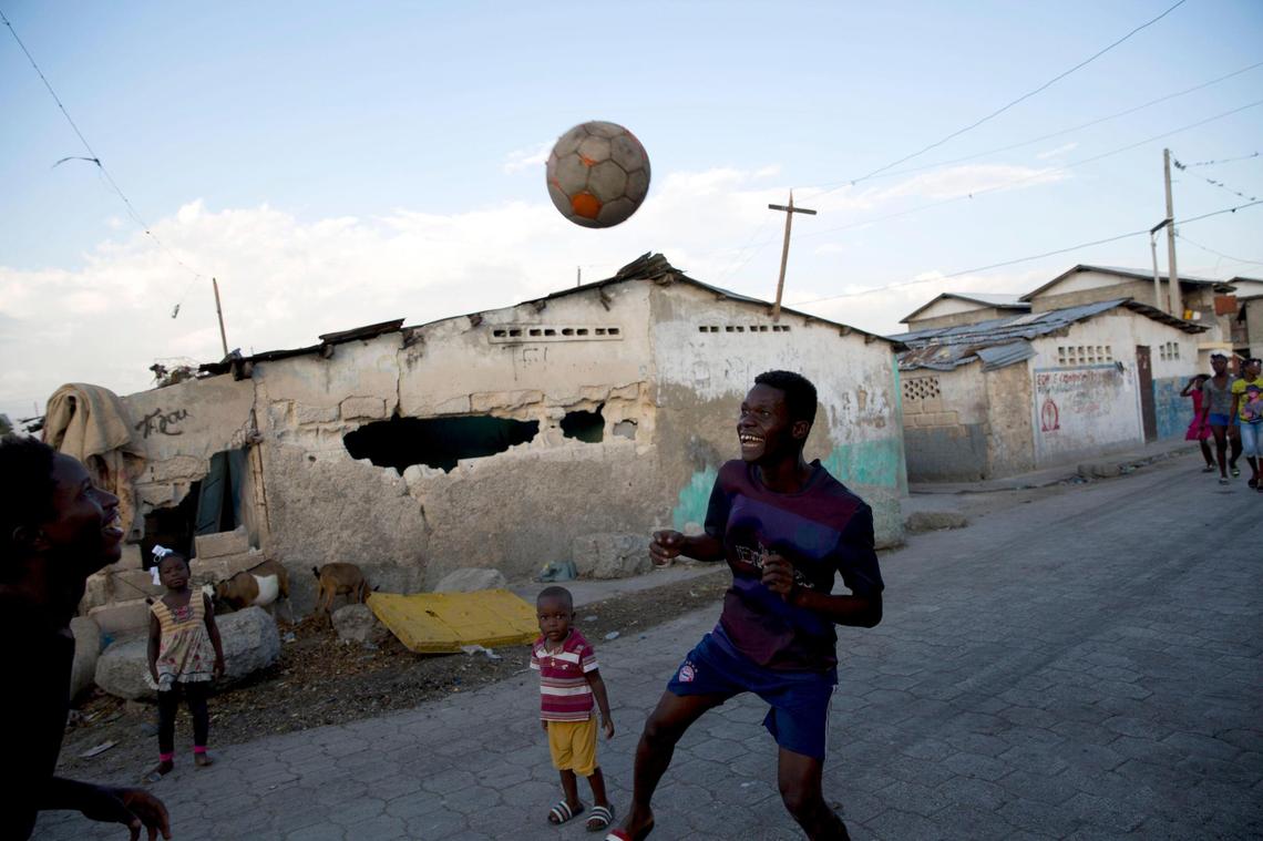 Youths play soccer in the Cite Soleil slum of Port-au-Prince, Haiti, on Feb. 11, 2020. At the time, the economy appeared to be shrinking and electricity was provided only a few hours a day in most of the capital.