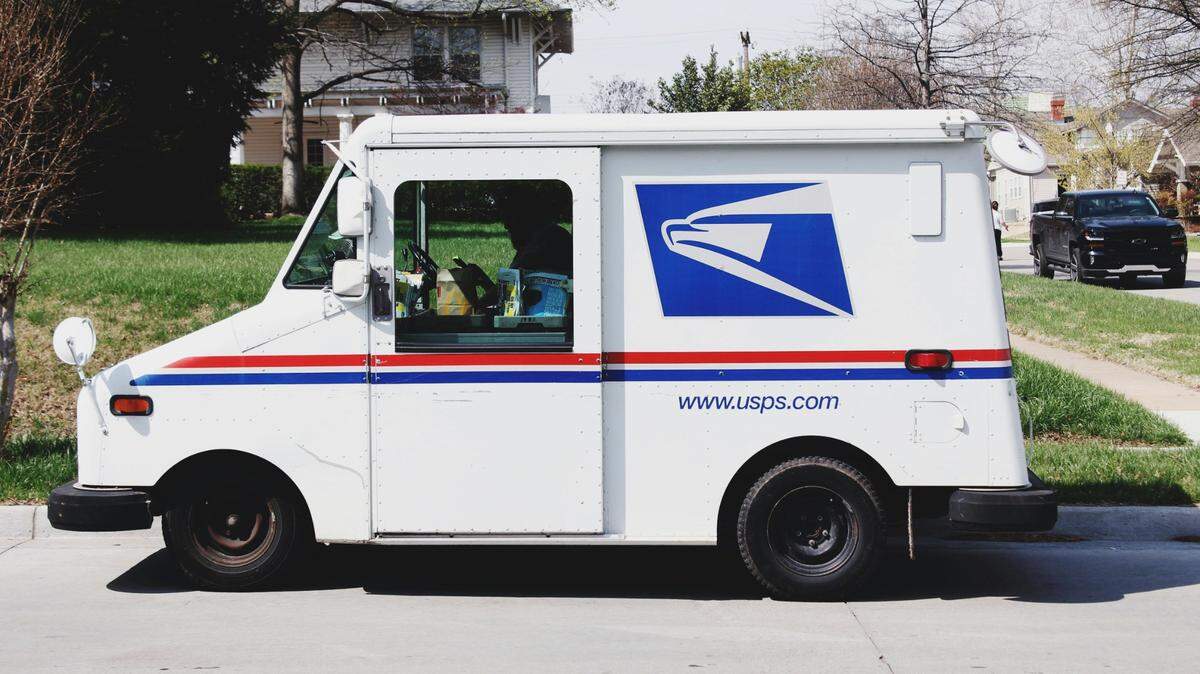 Two men are charged in Illinois after officials said one man robbed a mail carrier and another man shot at investigators.