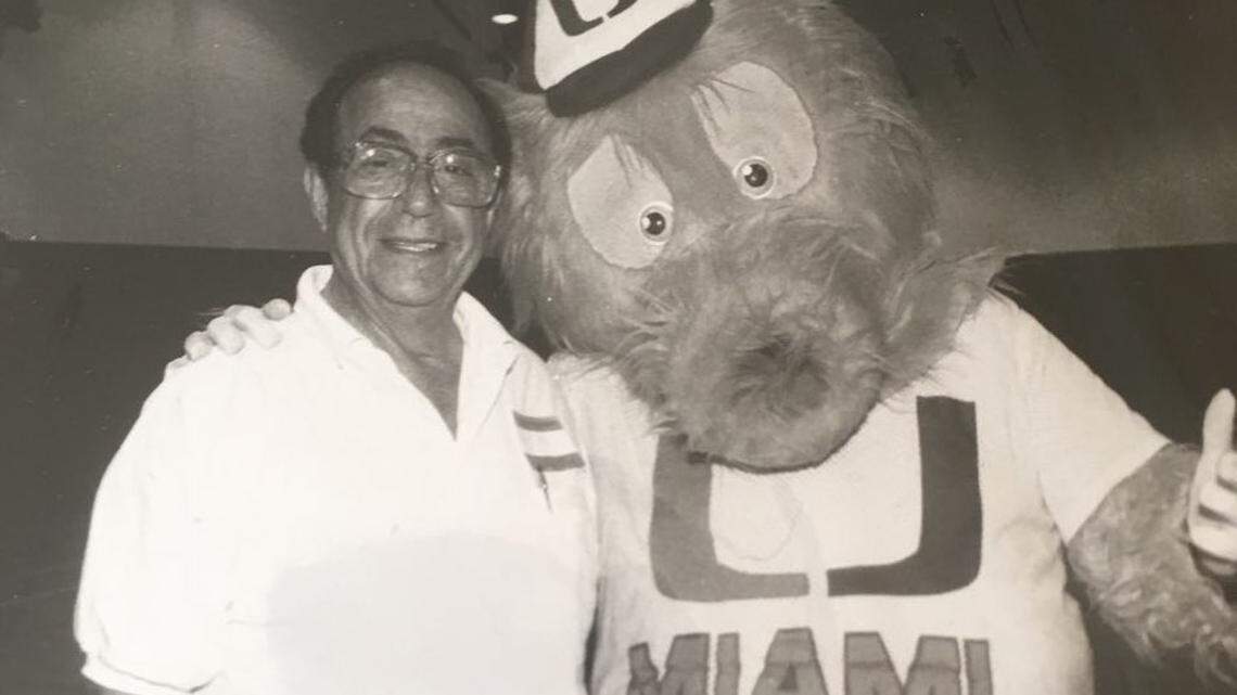 Irving Karp stands with the UM baseball mascot the Miami Maniac.
