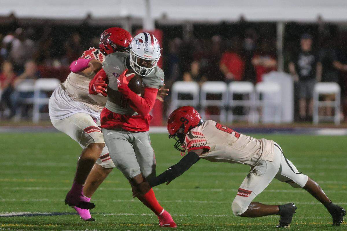Chaminade-Madonna Lions running back Derrek Cooper (1) carries the football against Monarch Knights defensive back Jayde Joselin (9) during the second quarter of a high school football game at Chaminade-Madonna College Preparatory school in Hollywood, Florida, Friday, October 3, 2025.