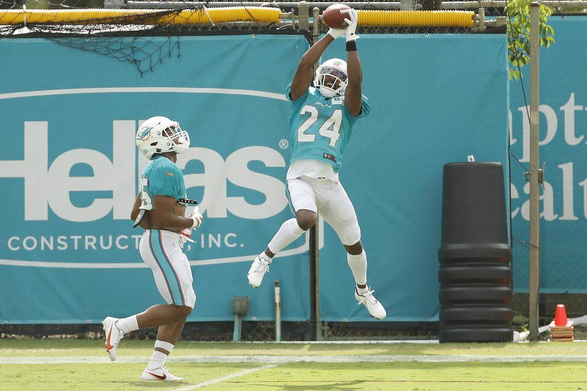 DAVIE, FLORIDA - AUGUST 24: Byron Jones #24 of the Miami Dolphins catches a pass during a drill during training camp at Baptist Health Training Complex at Nova Southern University on August 24, 2020 in Davie, Florida. (Photo by Michael Reaves/Getty Images)