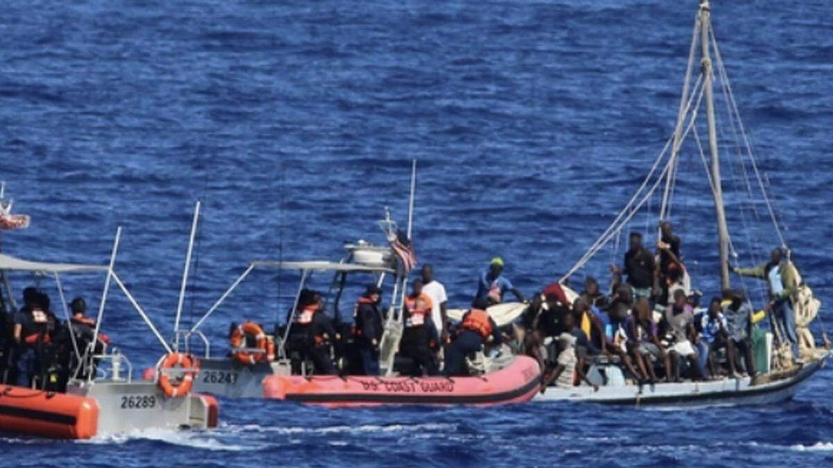 Crews with the Coast Guard Cutters Seneca and Raymond Evans stop a 33-foot a migrant vessel about 48 miles north of Cap-Haitian, Haiti, Friday, June 30, 2023.