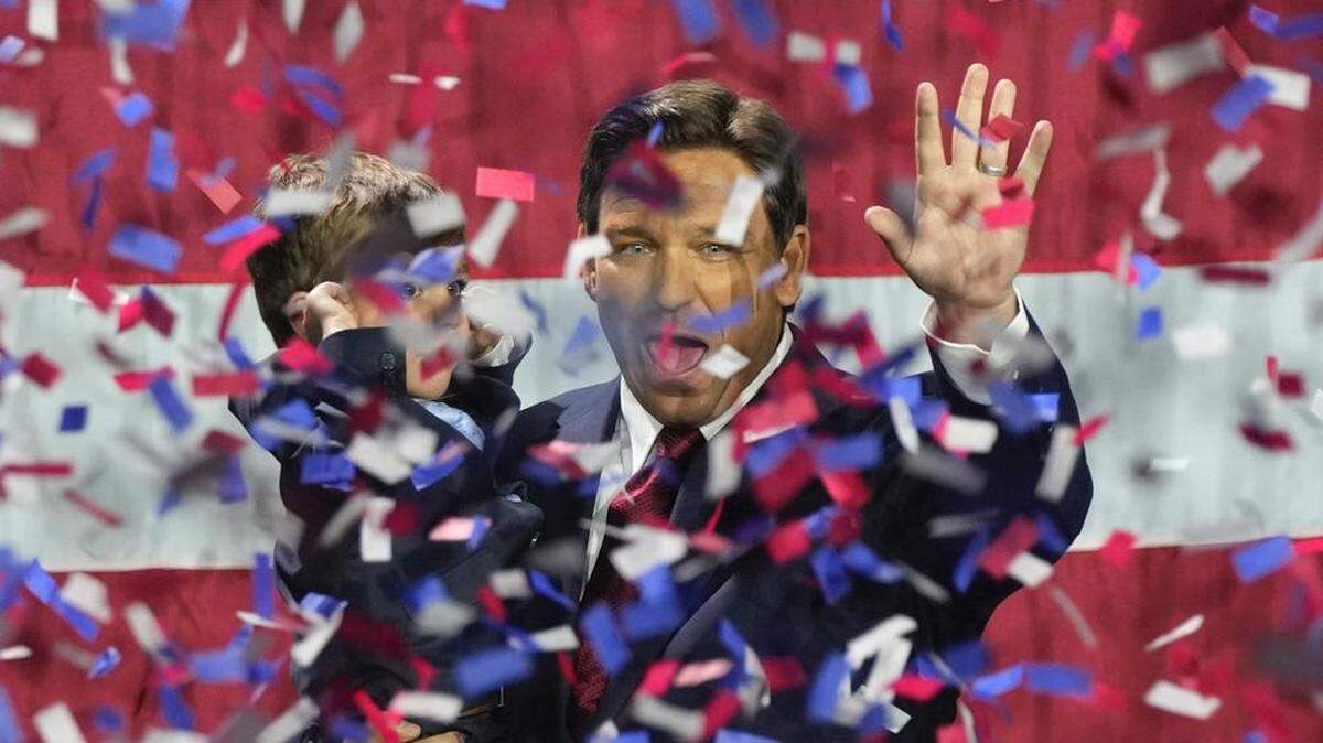 Florida Republican Gov. Ron DeSantis holds his son Mason as he celebrates winning reelection at an election night party in Tampa on Nov. 8.