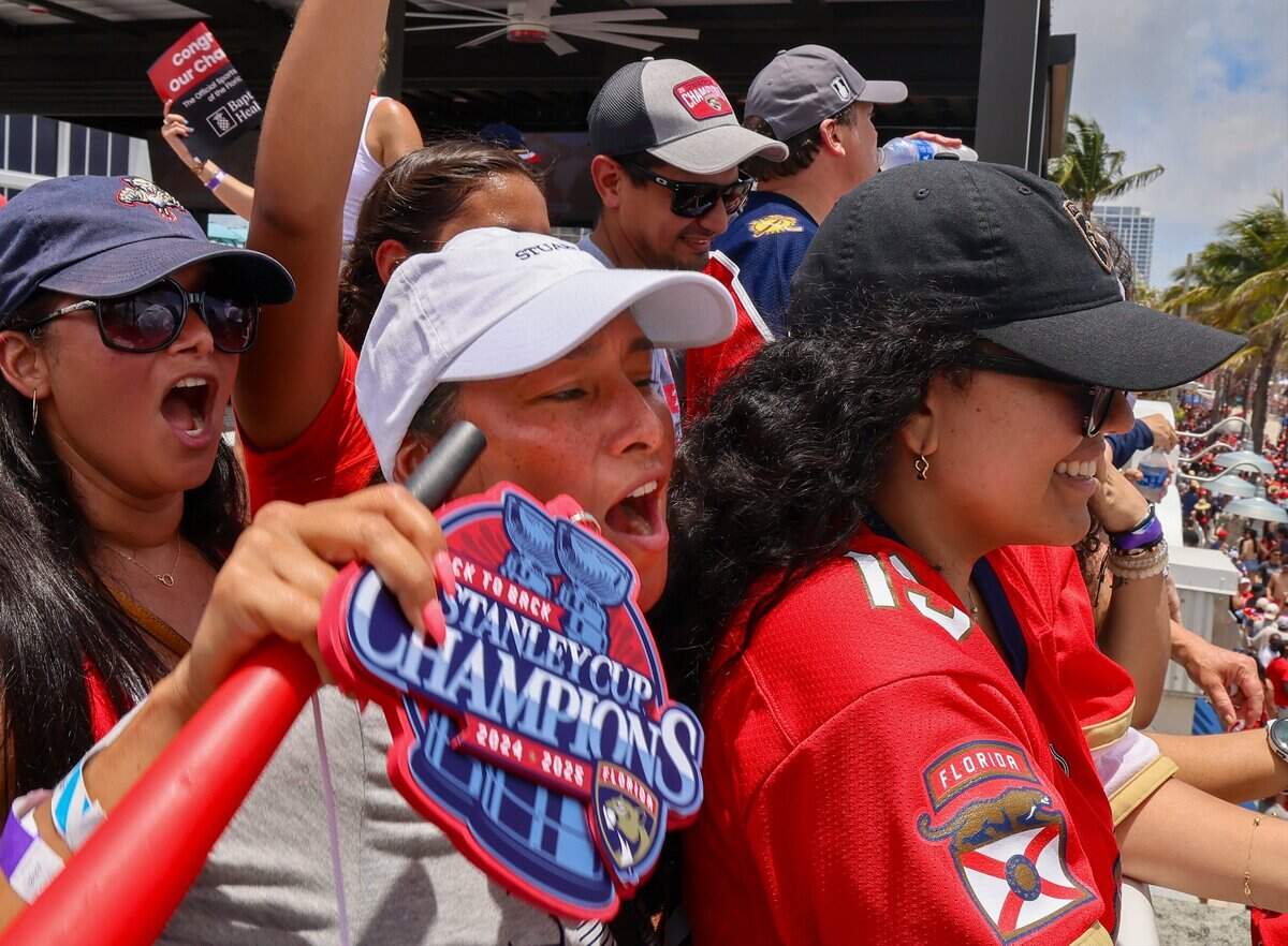 Panthers fans Maria Lopez of Miami, left, Sandra Gomez of Palm City, center, cheer the Panthers on the second consecutive Stanley Cup win on A1A just north of the staging area for the Florida Panthers Stanley Cup championship celebration parade on Sunday, June 22, 2025 in Fort Lauderdale, Florida.