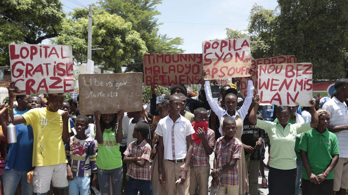 Students from the El Roi academy on Monday, January 31, 2023, carry signs during a demonstration to demand the freedom of New Hampshire nurse Alix Dorsainvil and her daughter, who have been reported kidnapped, in the Cite Soleil neighborhood of Port-au-Prince. Dorsainvil works for the El Roi Haiti nonprofit organization and the U.S. State Department issued a “do not travel advisory” ordering nonemergency personnel to leave the Caribbean nation amid growing security concerns.