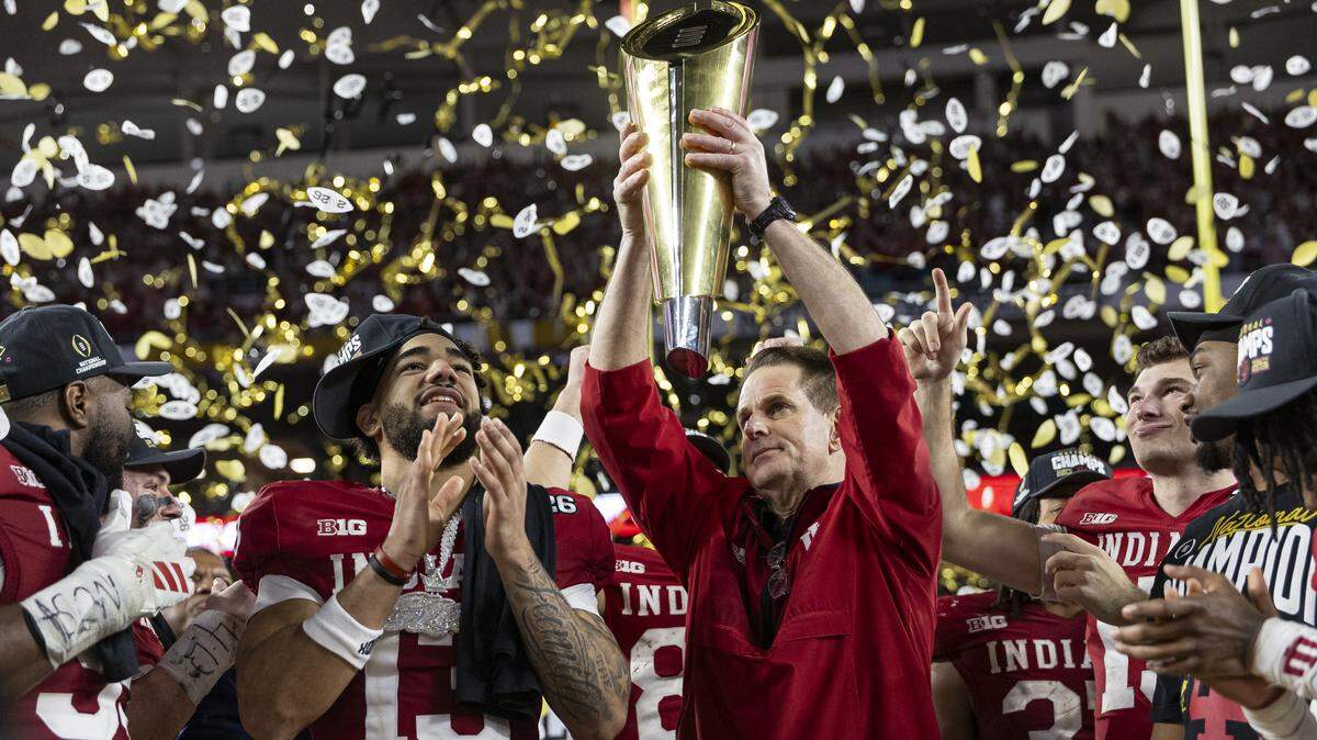Indiana Hoosiers head coach Curt Cignetti lifts the College Football Playoff National Championship Trophy after his College Football Playoff National Championship Game against the Miami Hurricanes at Hard Rock Stadium on Monday, Jan. 19, 2026, in Miami Gardens, Fla.